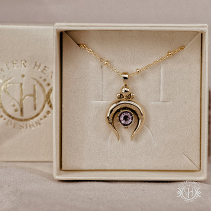 Hand-carved crescent moon pendant in brass with amethyst from the Primal Symbols collection. Symbolic jewelry made to order in brass, silver, and gold.