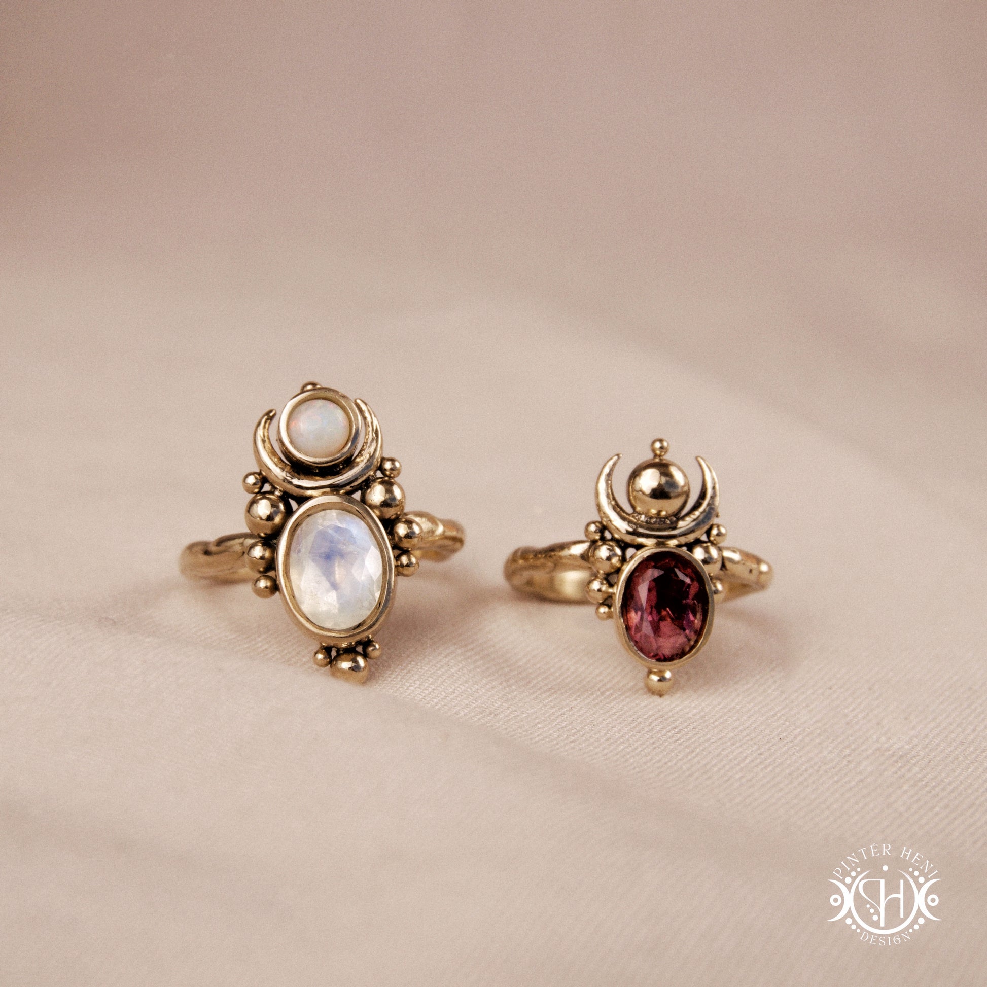 Hand-carved Nyx rings with opal, moonstone and garnet in brass, sculptural crescent design.