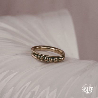 Orbit Ring – a circular Axial Form with repeating bead elements encircling the band. Handmade to order.