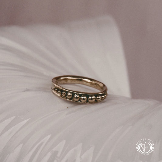 Orbit Ring – a circular Axial Form with repeating bead elements encircling the band. Handmade to order.