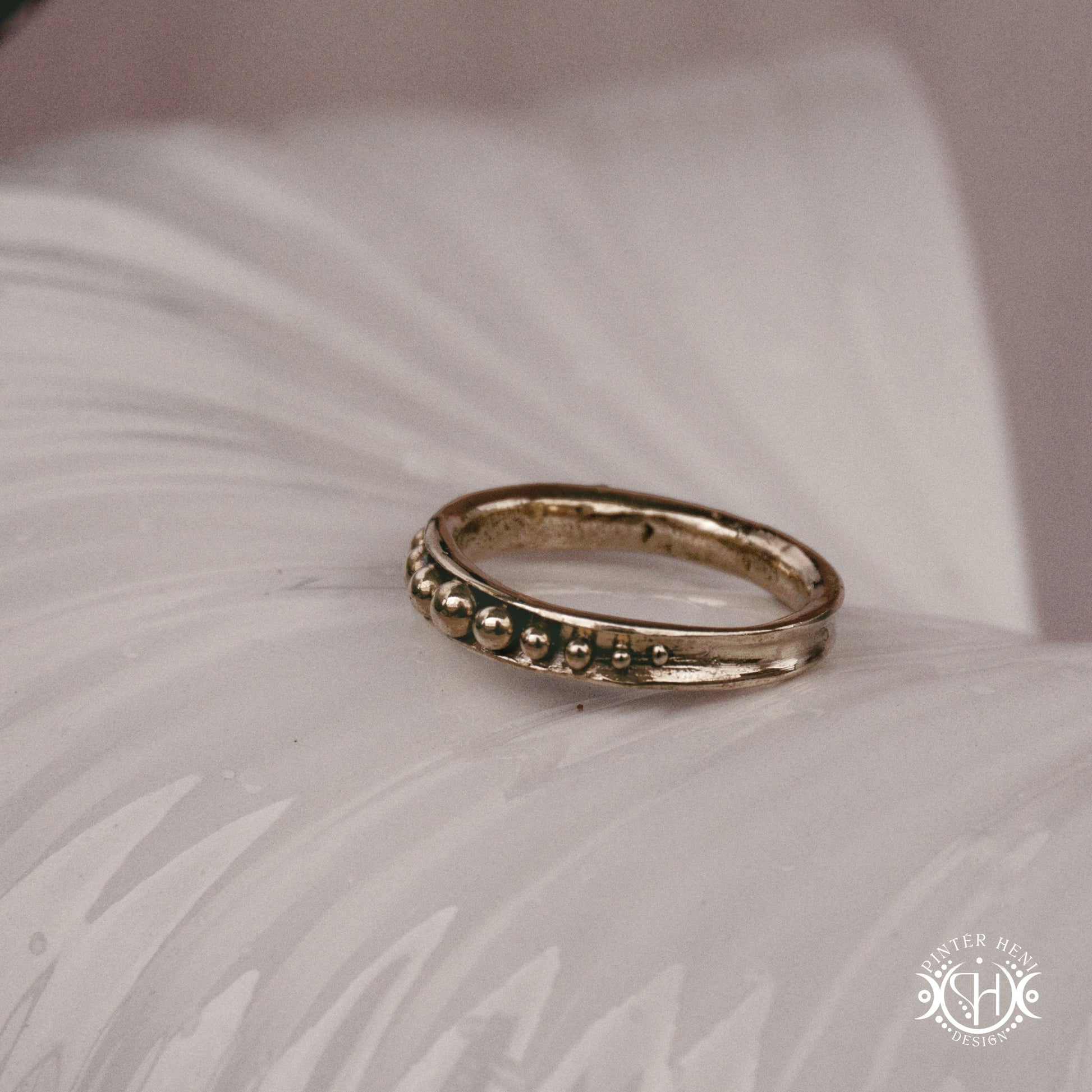 Orbit Ring – a circular Axial Form with repeating bead elements encircling the band. Handmade to order.