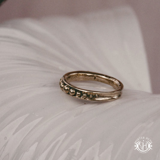 Orbit Ring – a circular Axial Form with repeating bead elements encircling the band. Handmade to order.