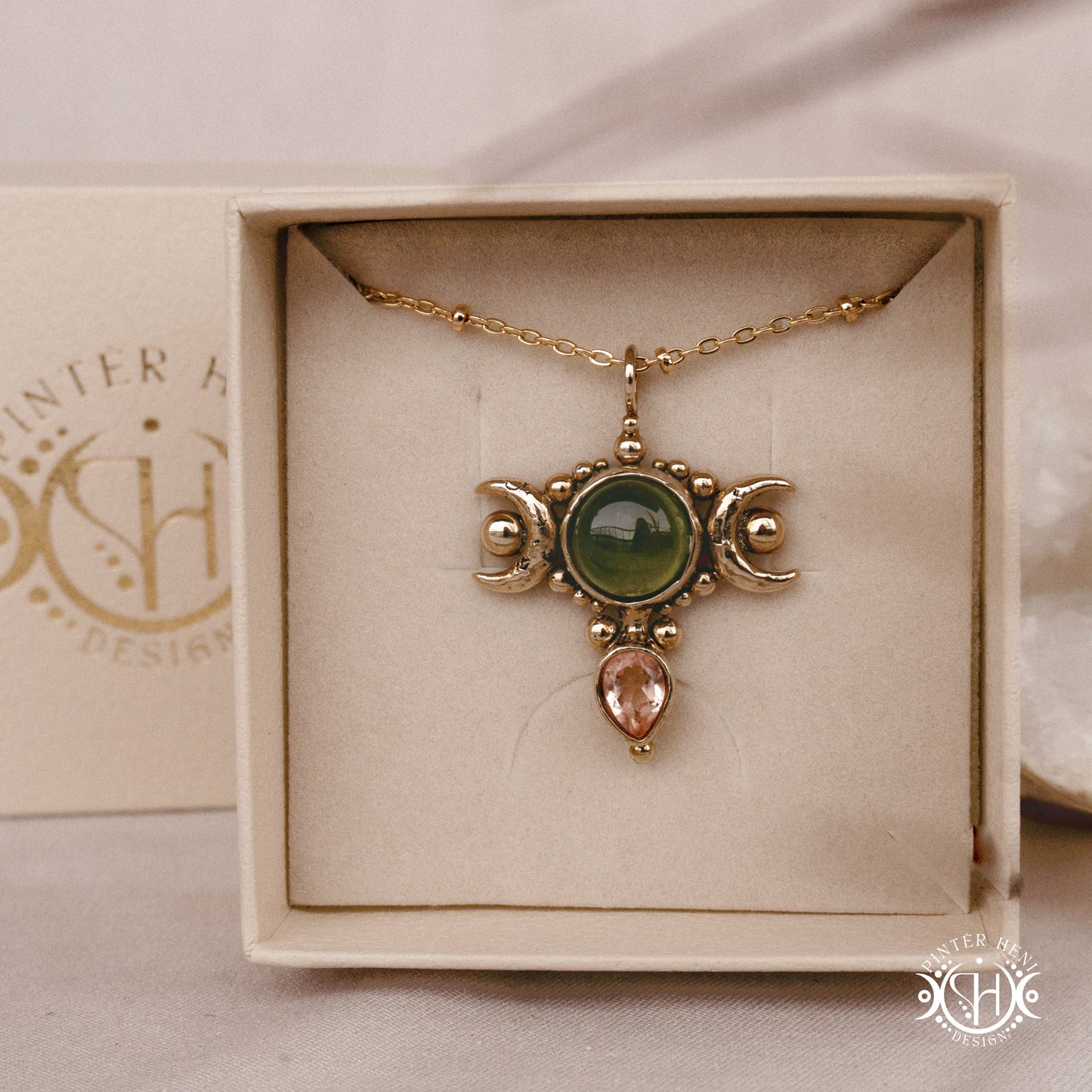Hand-carved Selene crescent pendant with vesuvianite and morganite.