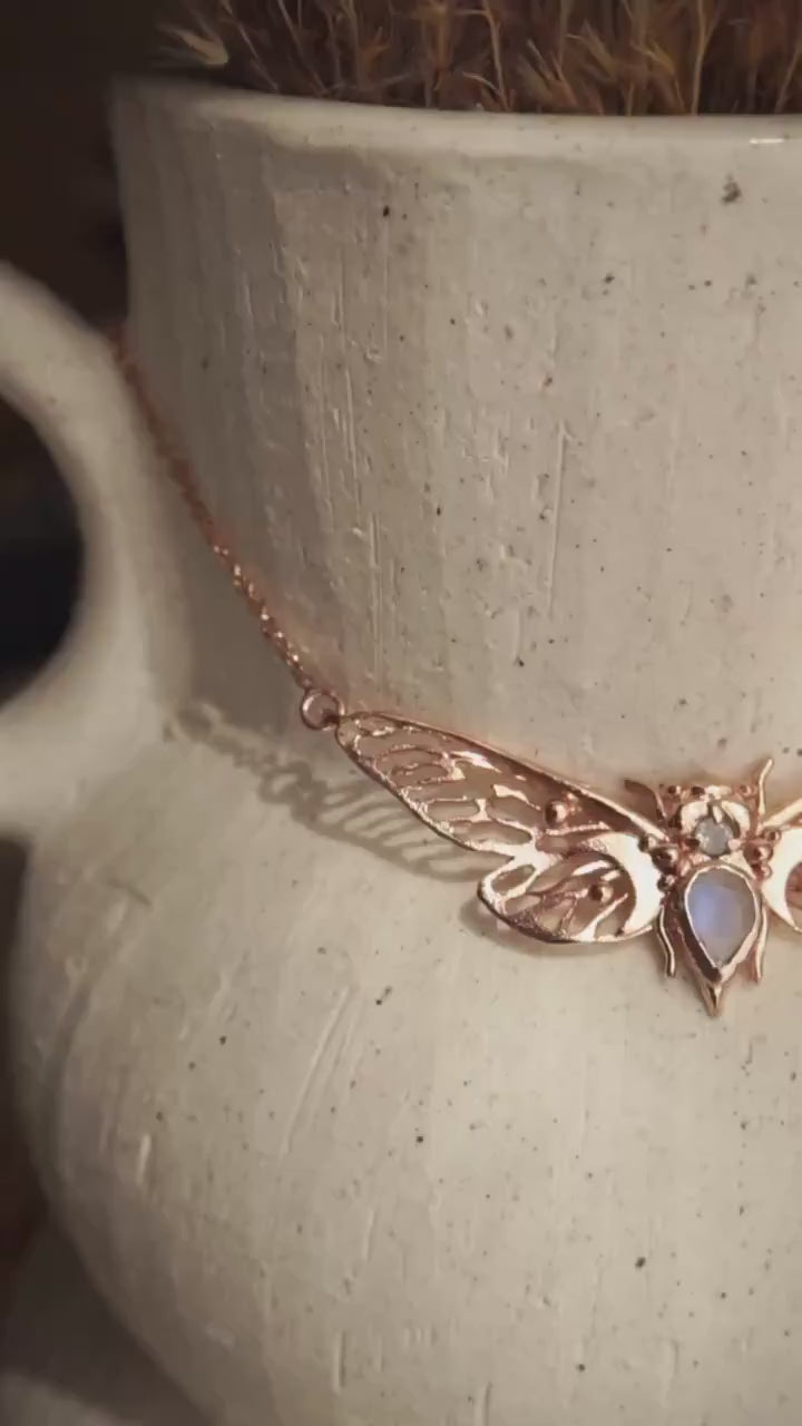 Handcrafted cicada pendant with moonstone in rose gold.