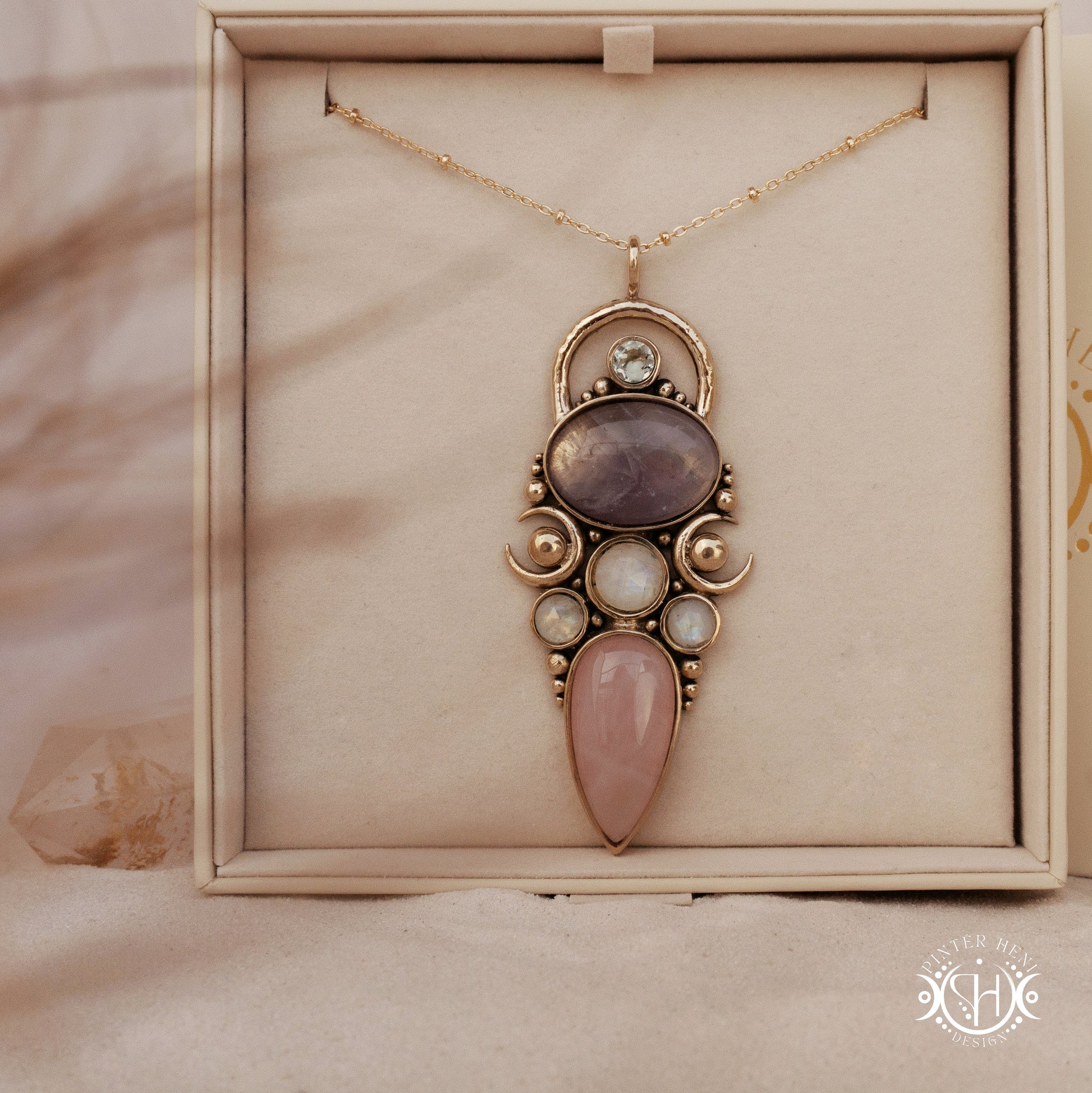 Hand-carved Rhea pendant with rose quartz, amethyst, moonstone and prasiolite, in branded jewelry box.