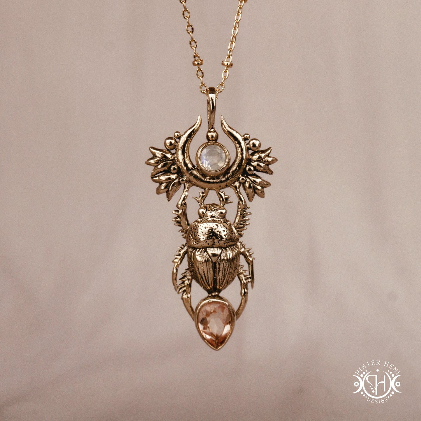 Scarab pendant in brass with moonstone and morganite, front view