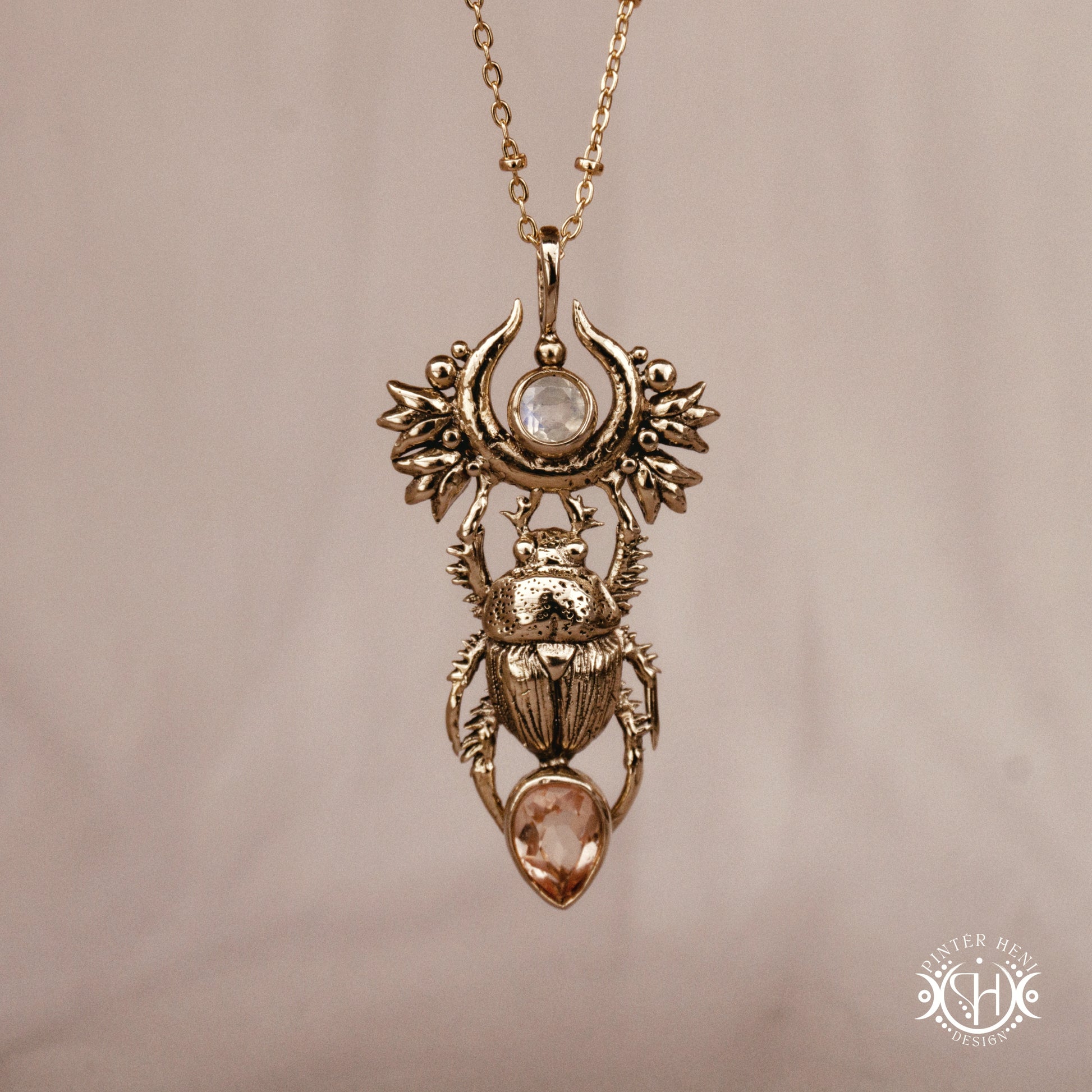 Scarab pendant in brass with moonstone and morganite, front view
