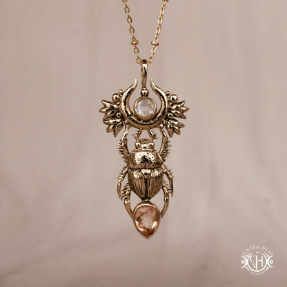 Scarab pendant in brass with moonstone and morganite, front view