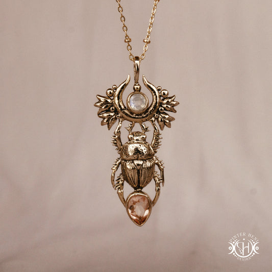 Scarab pendant in brass with moonstone and morganite, front view