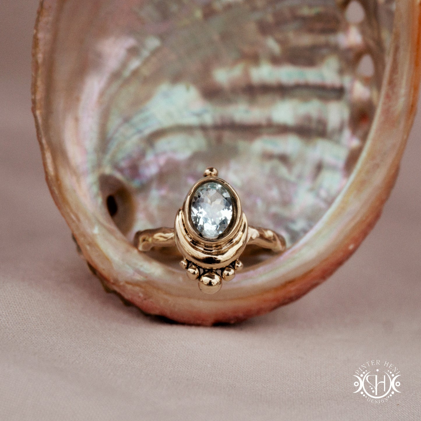 Handmade oval aquamarine gemstone ring set within a crescent-inspired form, in a shell