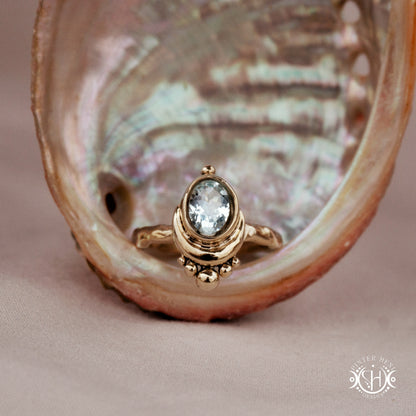 Handmade oval aquamarine gemstone ring set within a crescent-inspired form, in a shell