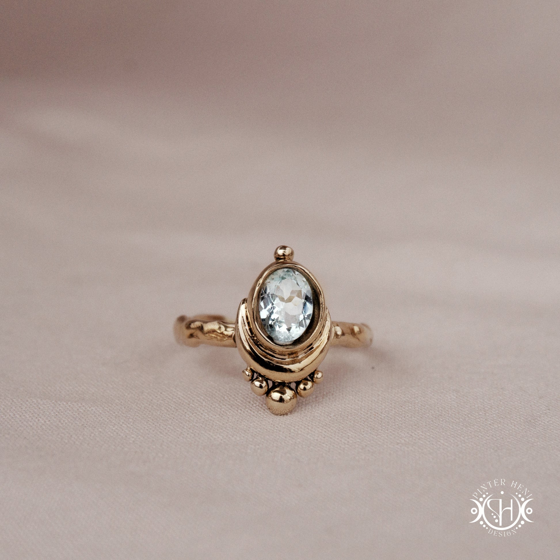 Handmade oval aquamarine gemstone ring set within a crescent-inspired form