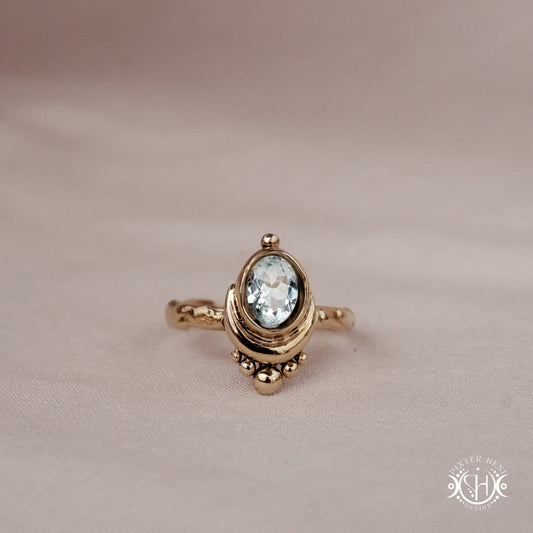 Handmade oval aquamarine gemstone ring set within a crescent-inspired form