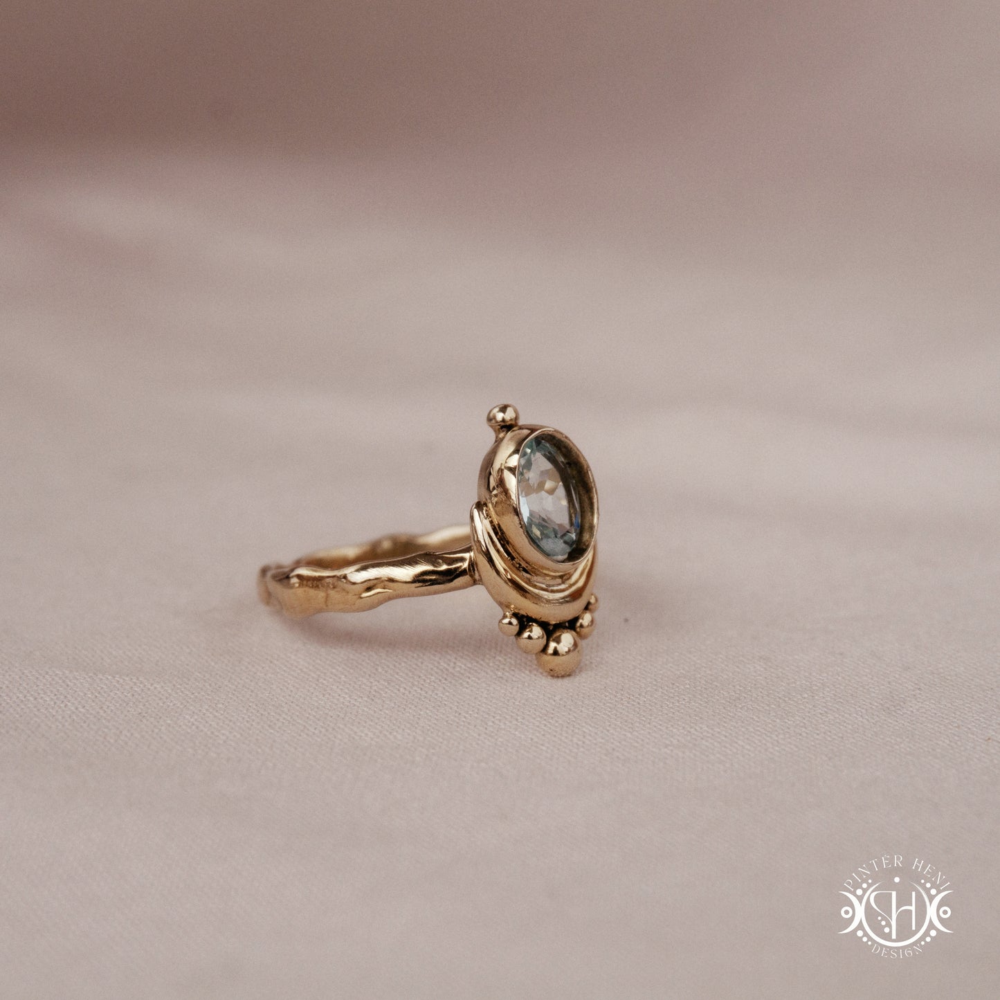 Handmade oval aquamarine gemstone ring set within a crescent-inspired form