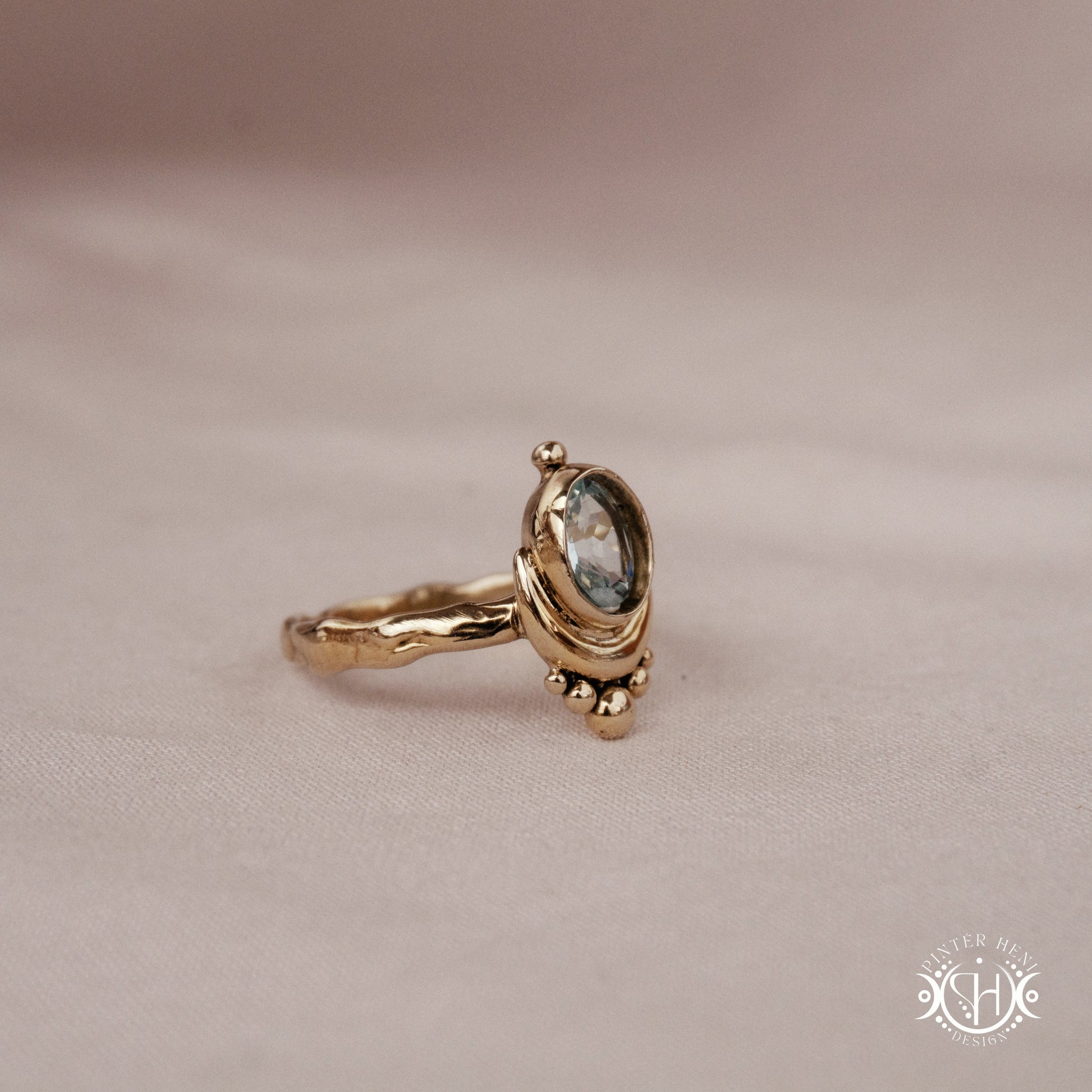 Handmade oval aquamarine gemstone ring set within a crescent-inspired form