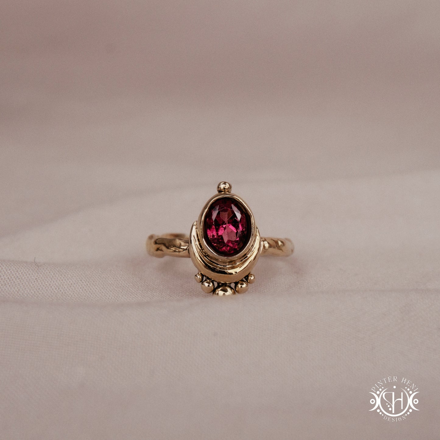 Handmade oval garnet gemstone ring set within a crescent-inspired form