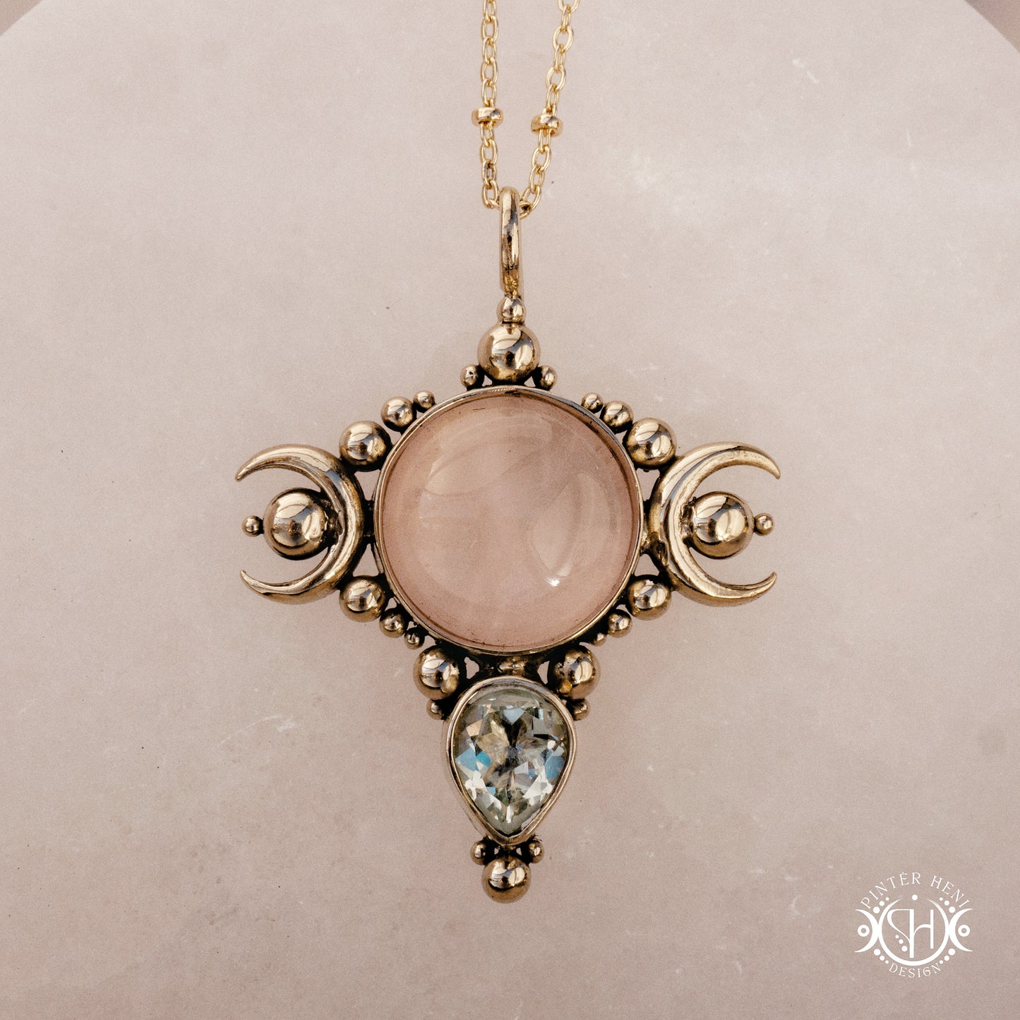 Hand-carved Selene crescent pendant with rose quartz and prasiolite.
