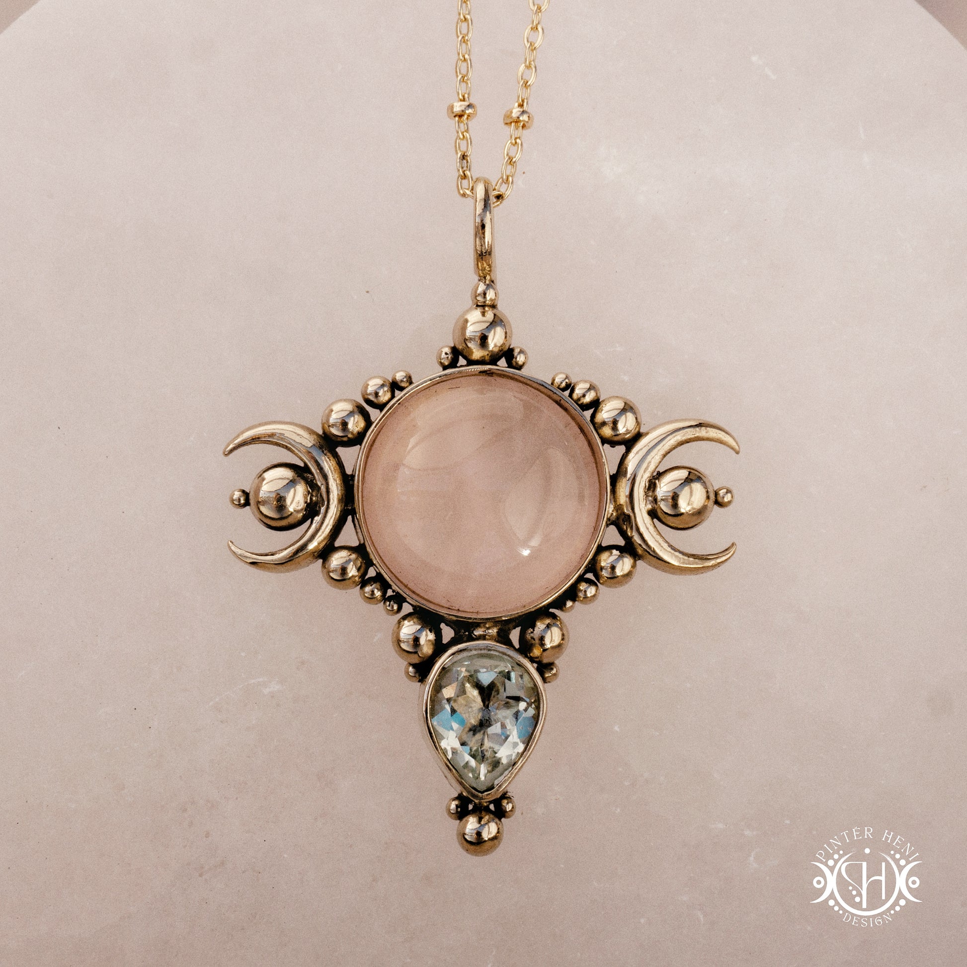 Hand-carved Selene crescent pendant with rose quartz and prasiolite.