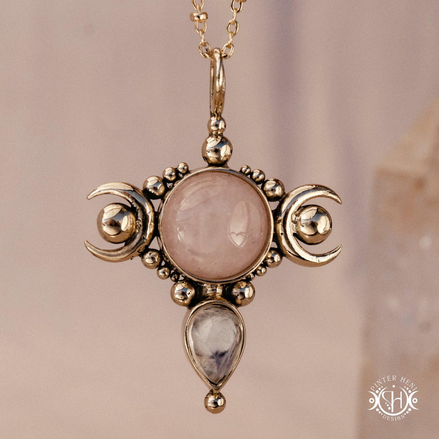 Hand-carved Selene crescent pendant with rose quartz and moonstone.