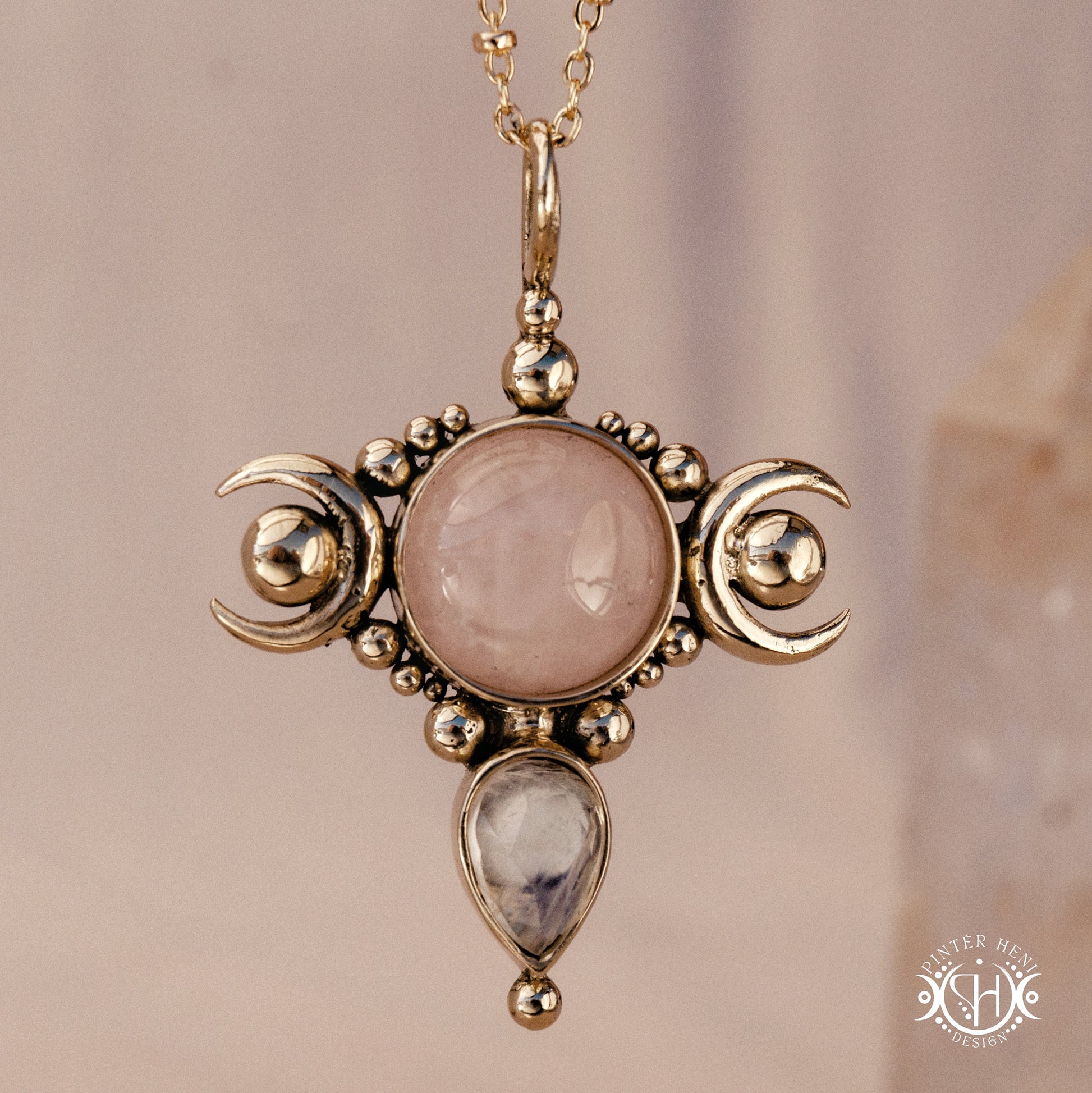 Hand-carved Selene crescent pendant with rose quartz and moonstone.