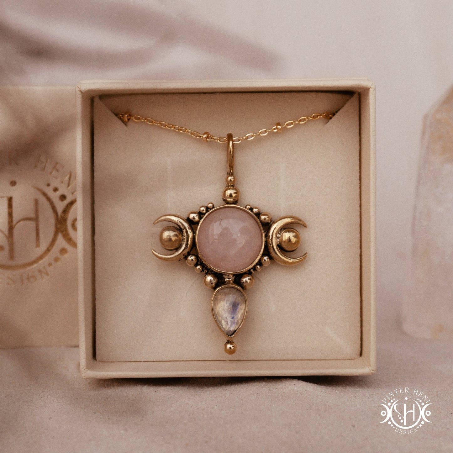Hand-carved Selene crescent pendant with rose quartz and moonstone.