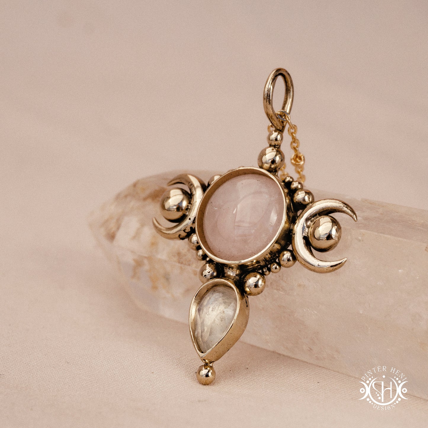 Hand-carved Selene crescent pendant with rose quartz and moonstone.