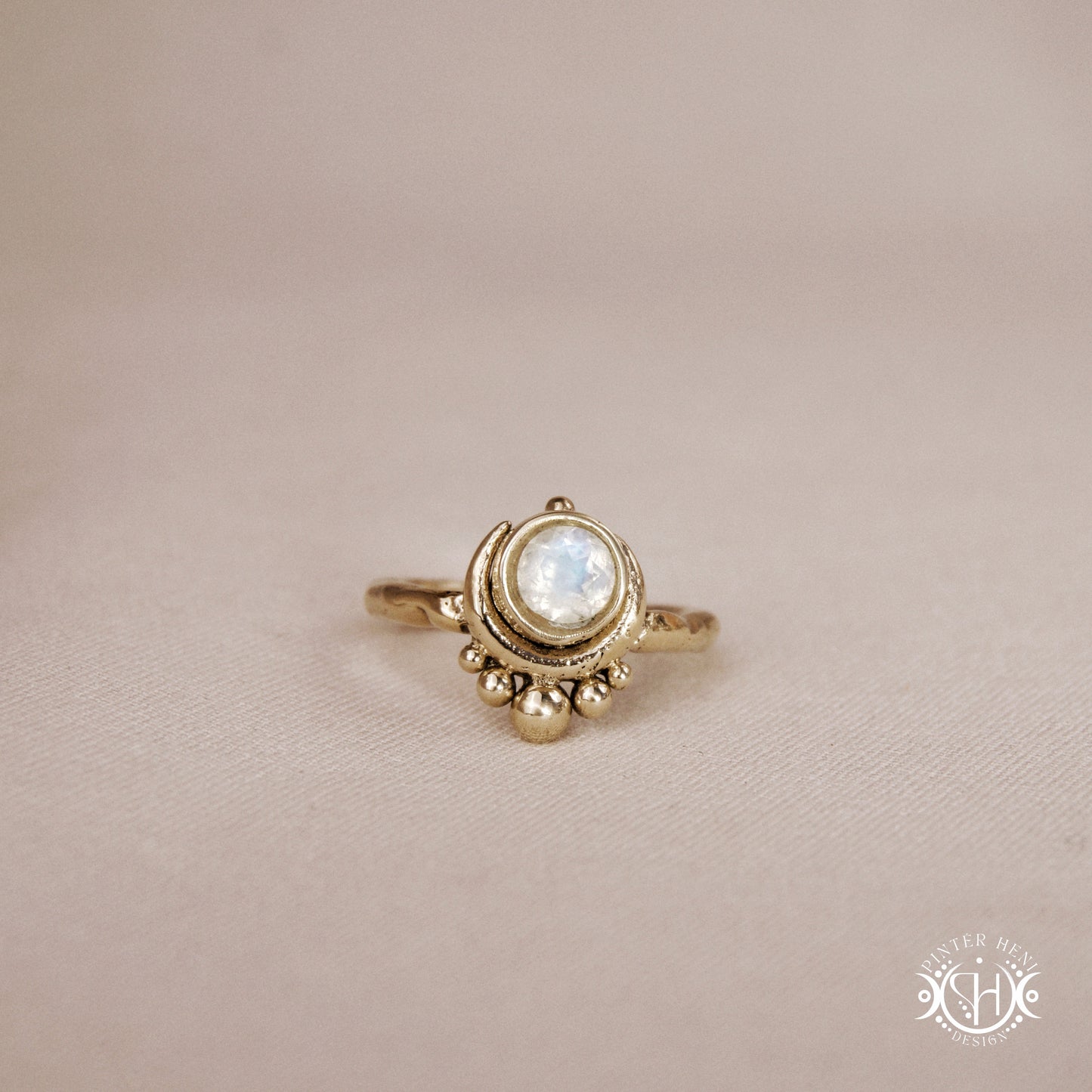 Handmade crescent moon ring with round moonstone set inside the lunar curve