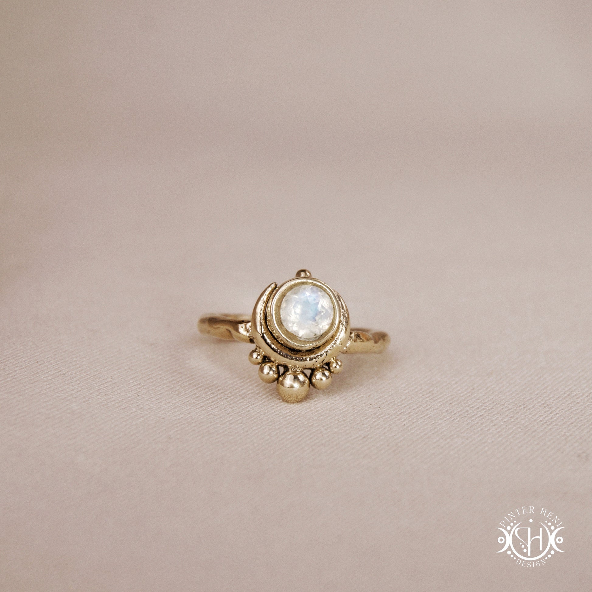 Handmade crescent moon ring with round moonstone set inside the lunar curve
