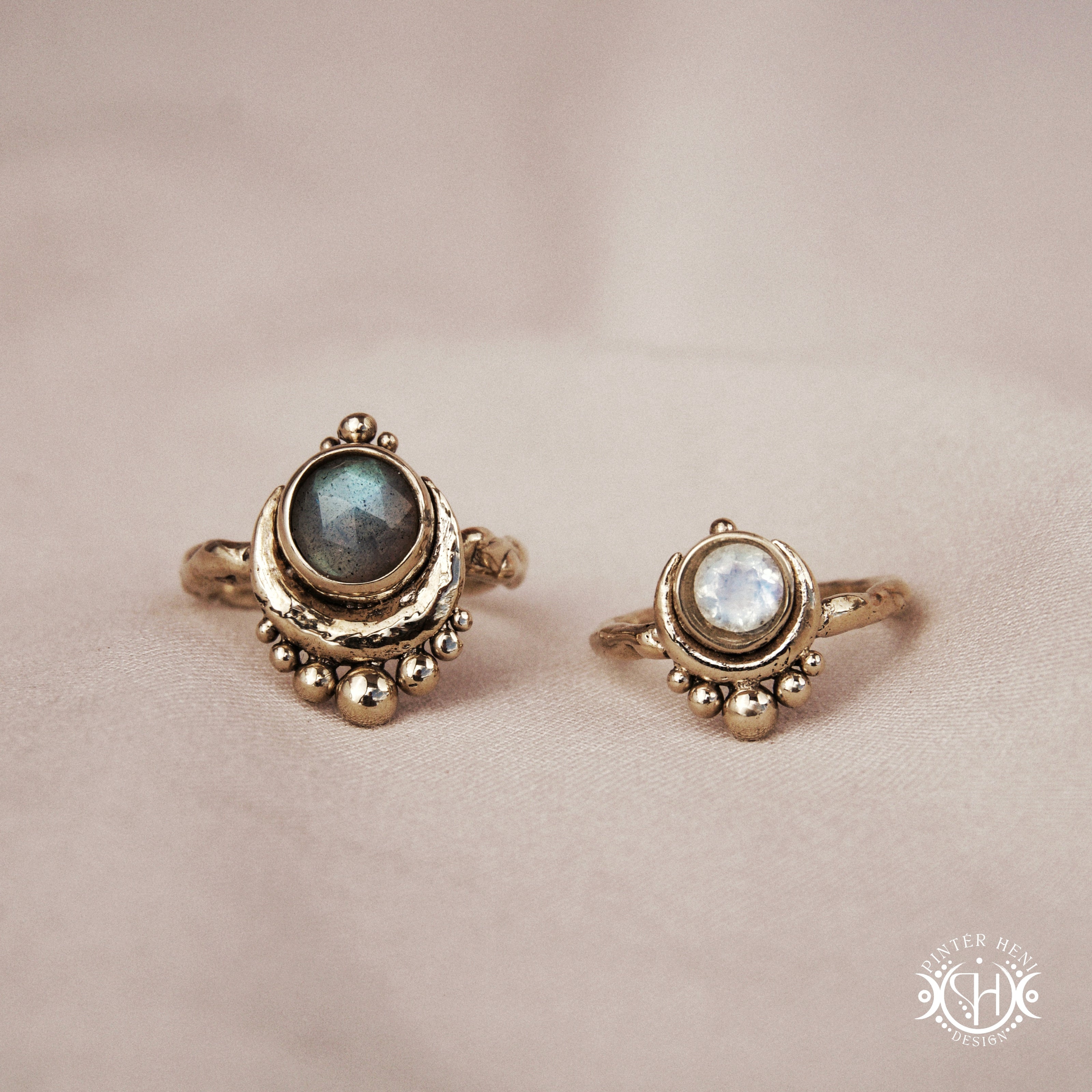 Handmade crescent moon rings with round moonstone and labradorite set inside the lunar curve