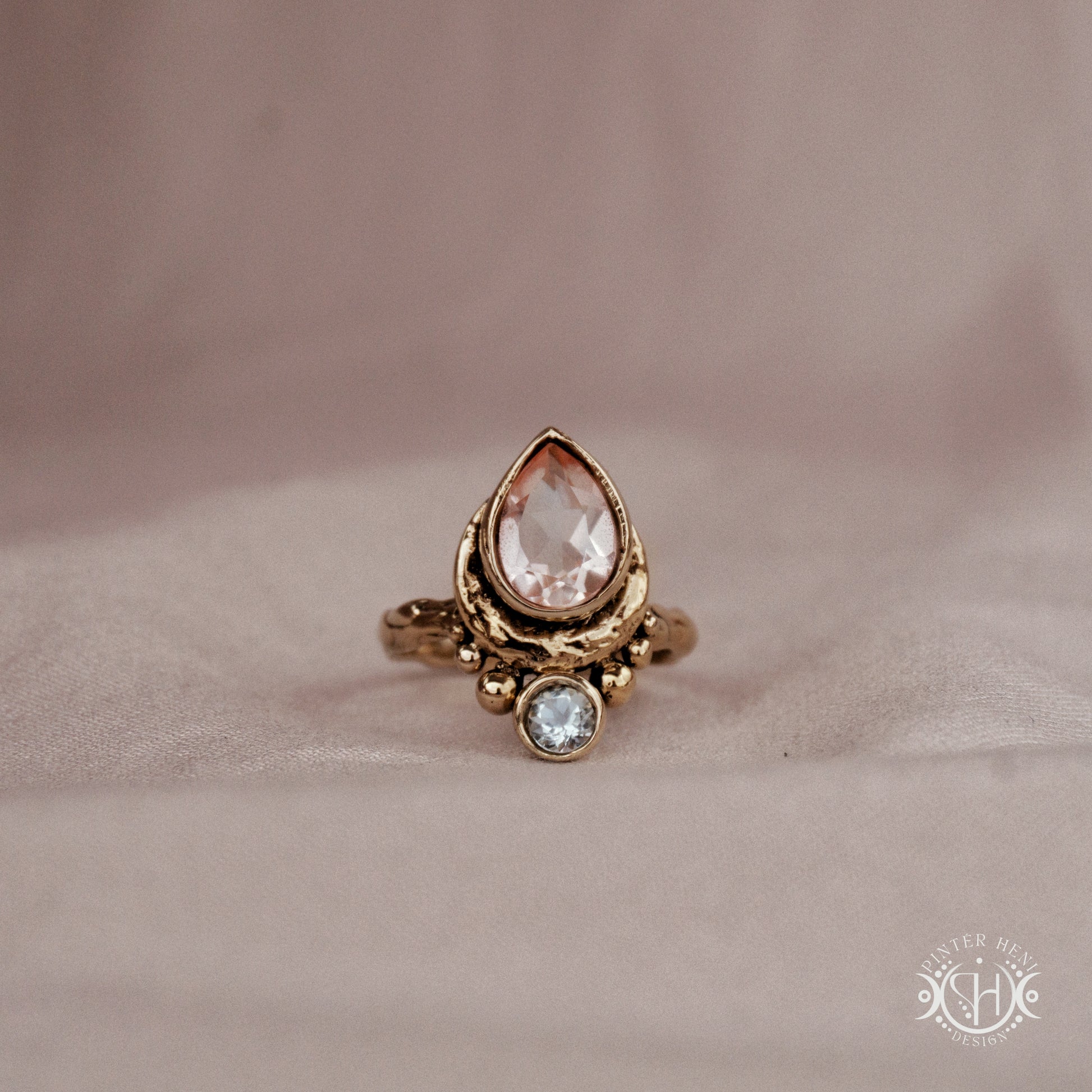 Handmade brass teardrop ring with morganite and aquamarine set in crescent-inspired form