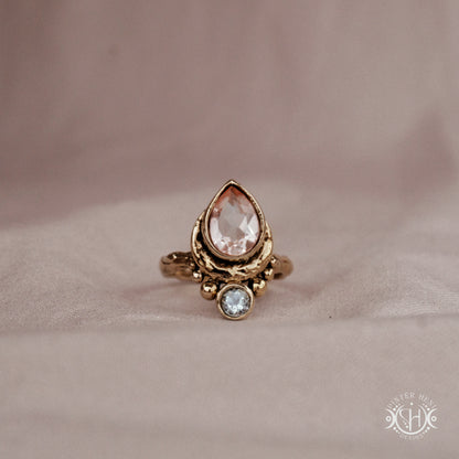 Handmade brass teardrop ring with morganite and aquamarine set in crescent-inspired form