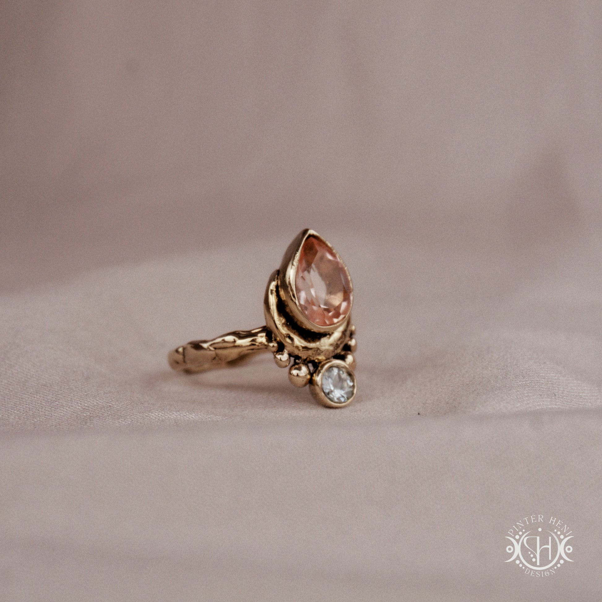 Handmade brass teardrop ring with morganite and aquamarine set in crescent-inspired form