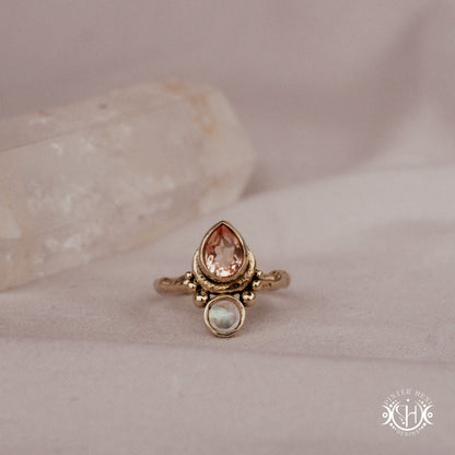 Handmade brass teardrop ring with morganite and moonstone set in crescent-inspired form