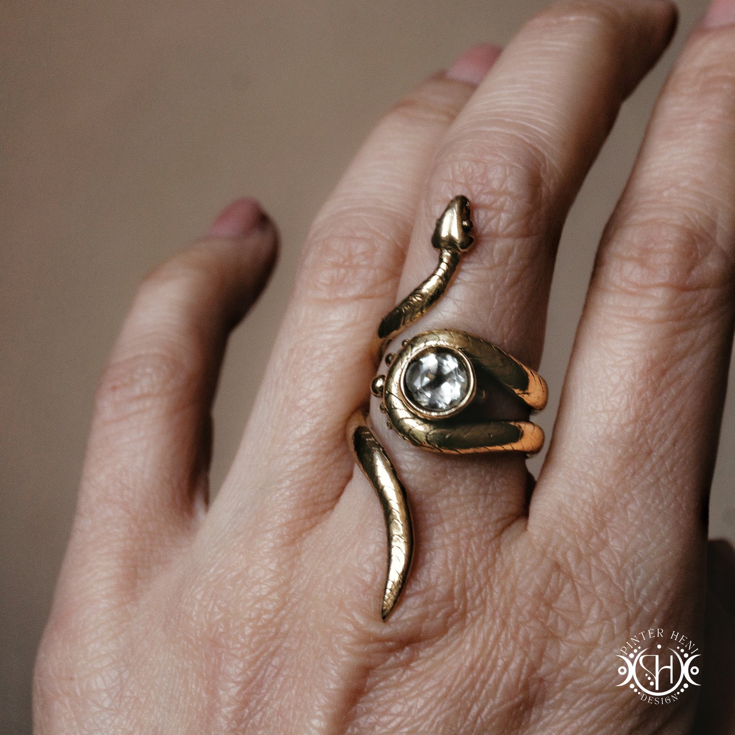 Handmade adjustable serpent ring set with prasiolite, sculptural wax carved design in brass, worn on hand.