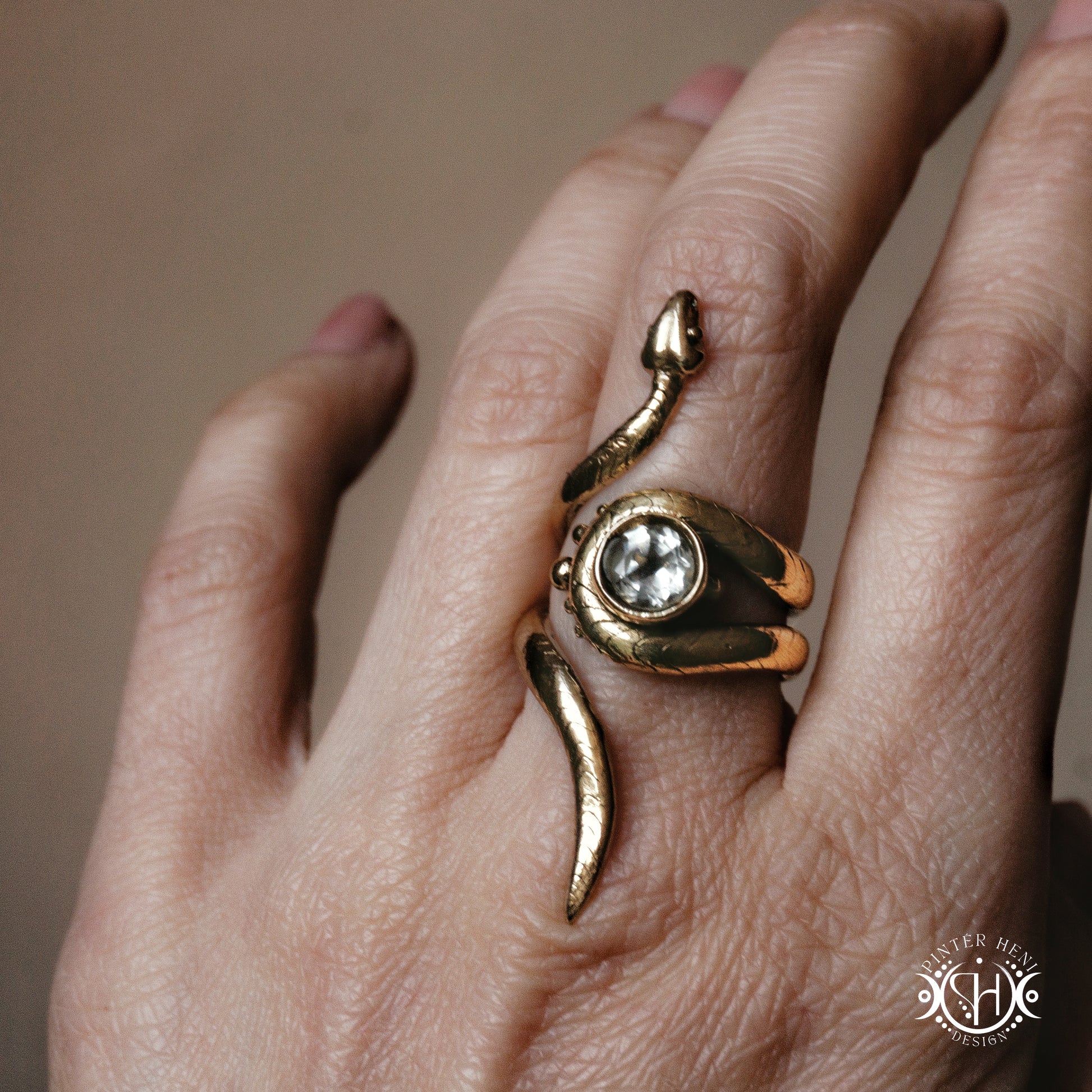 Handmade adjustable serpent ring set with prasiolite, sculptural wax carved design in brass, worn on hand.