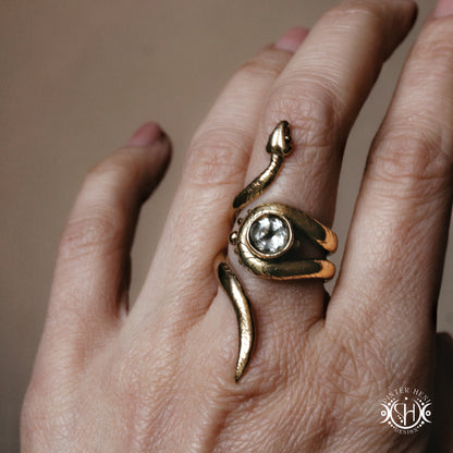 Handmade adjustable serpent ring set with prasiolite, sculptural wax carved design in brass, worn on hand.