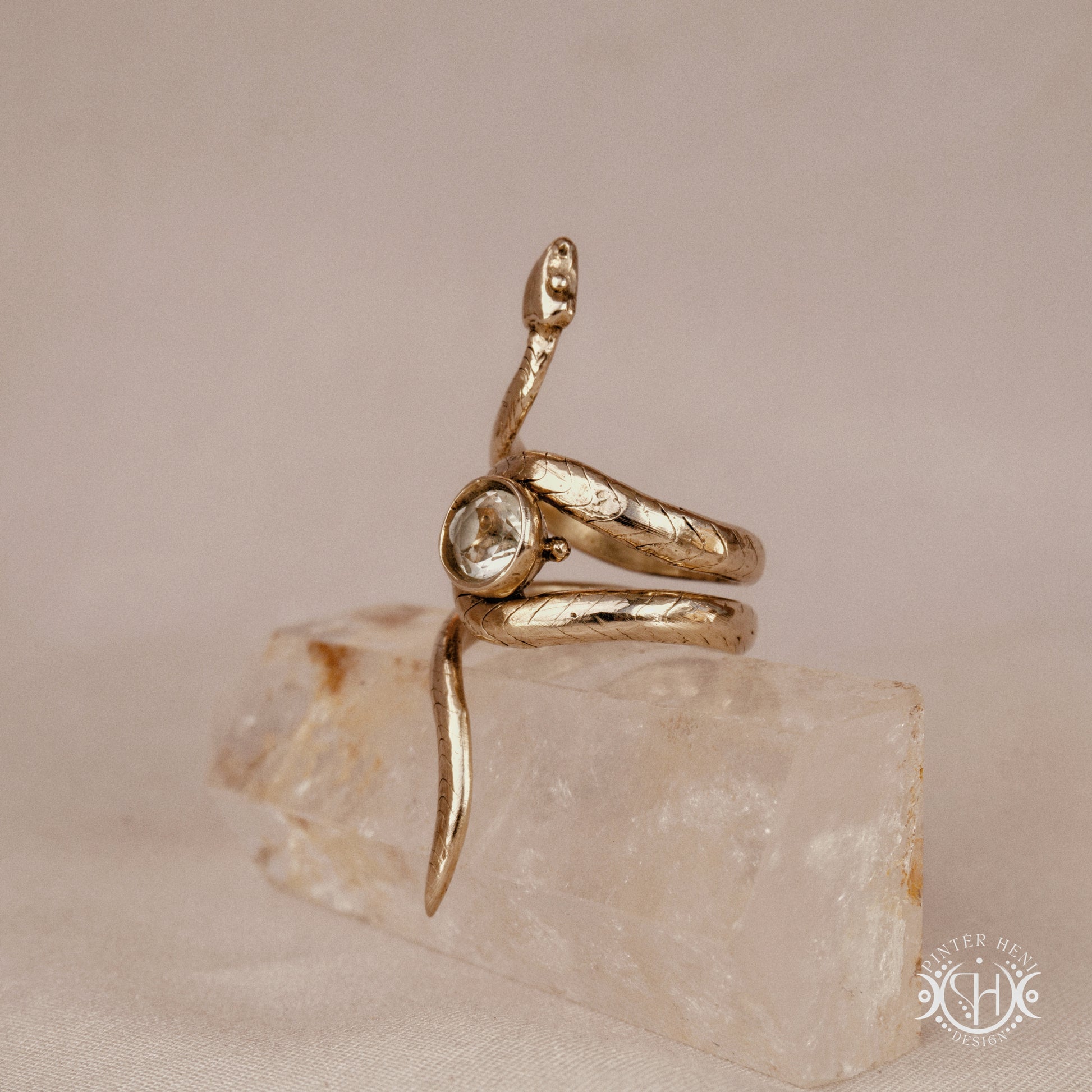 Handmade adjustable serpent ring set with prasiolite, sculptural wax carved design in brass, silver, or solid gold, side view.