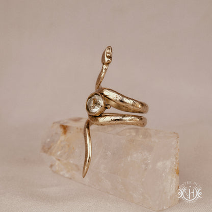 Handmade adjustable serpent ring set with prasiolite, sculptural wax carved design in brass, silver, or solid gold, side view.