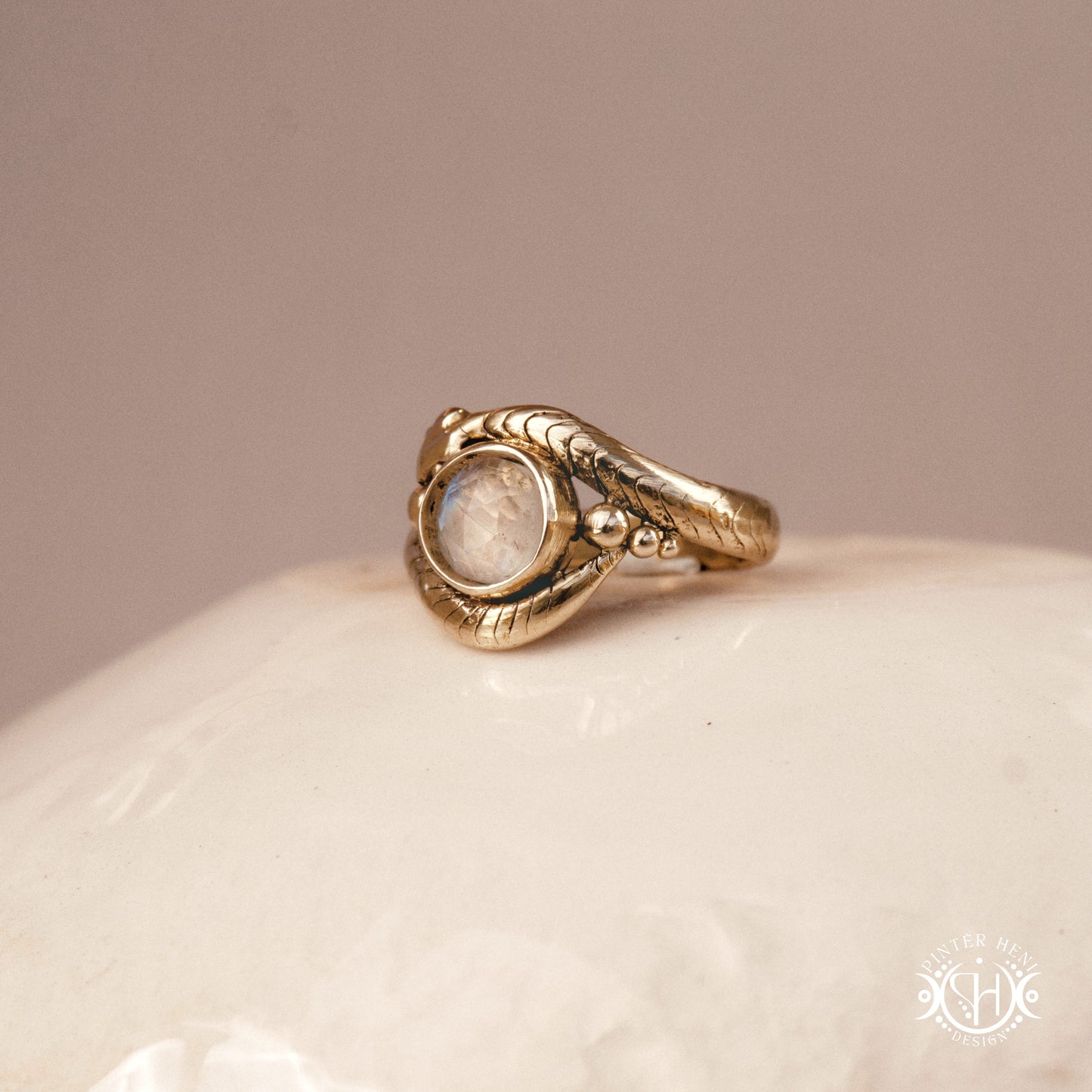 Handmade serpent ring set with moonstone, sculptural wax carved design in brass, silver, or solid gold, side view.