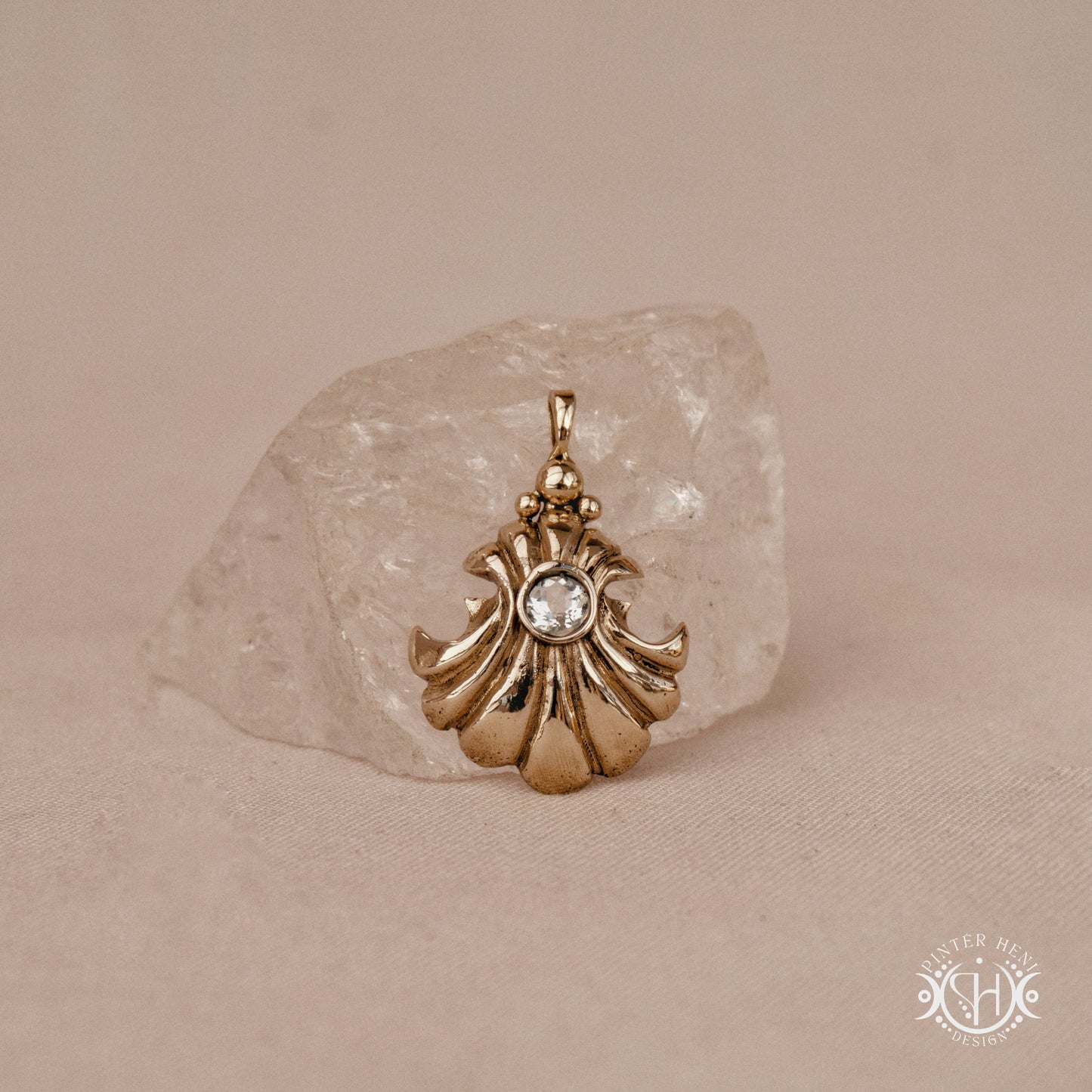 Hand-carved shell pendant in brass with organic surface from the Primal Symbols collection. Symbolic jewelry made to order in brass, silver, and gold.