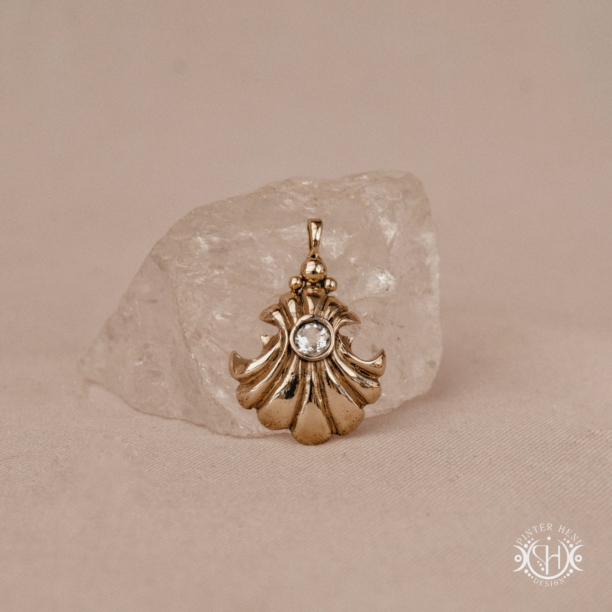 Hand-carved shell pendant in brass with organic surface from the Primal Symbols collection. Symbolic jewelry made to order in brass, silver, and gold.