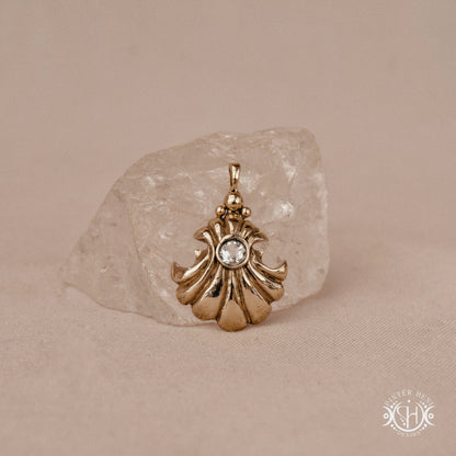 Hand-carved shell pendant in brass with organic surface from the Primal Symbols collection. Symbolic jewelry made to order in brass, silver, and gold.