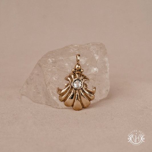 Hand-carved shell pendant in brass with organic surface from the Primal Symbols collection. Symbolic jewelry made to order in brass, silver, and gold.