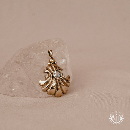 Hand-carved shell pendant in brass with organic surface from the Primal Symbols collection. Symbolic jewelry made to order in brass, silver, and gold.