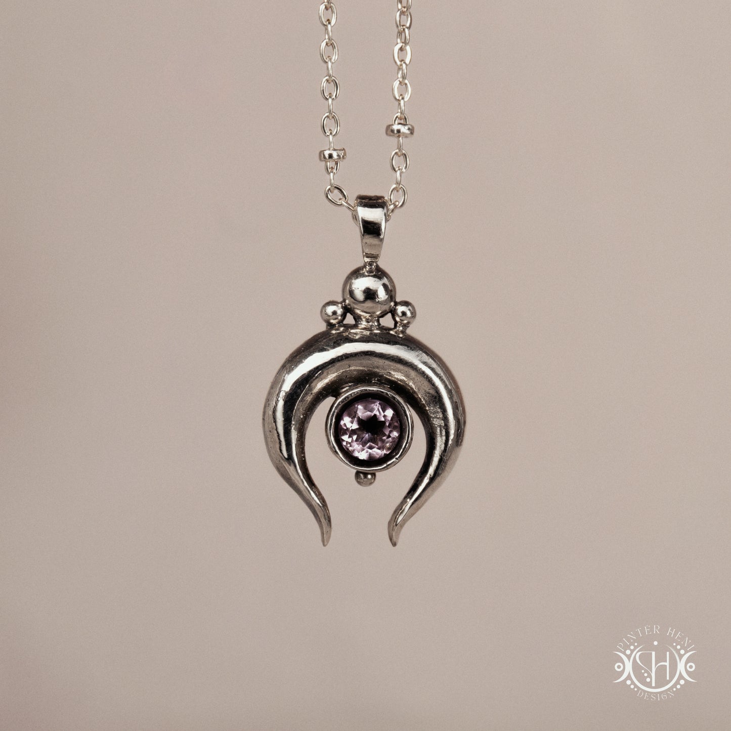 Hand-carved crescent moon pendant in sterling silver with amethyst from the Primal Symbols collection. Symbolic jewelry made to order in brass, silver, and gold.