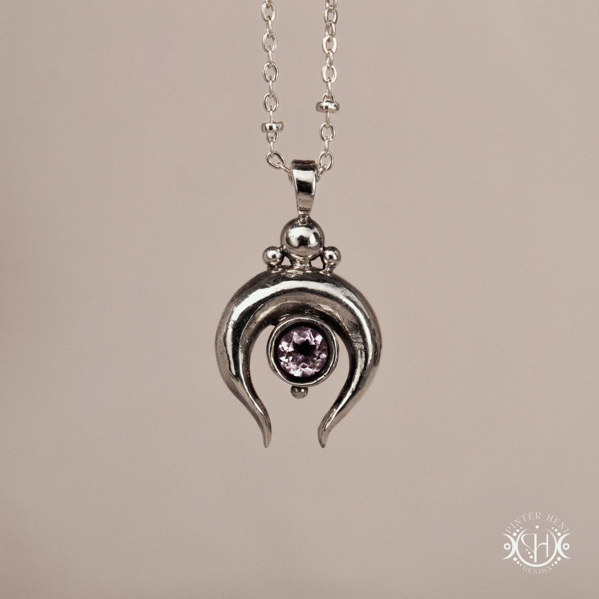 Hand-carved crescent moon pendant in sterling silver with amethyst from the Primal Symbols collection. Symbolic jewelry made to order in brass, silver, and gold.