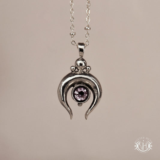 Hand-carved crescent moon pendant in sterling silver with amethyst from the Primal Symbols collection. Symbolic jewelry made to order in brass, silver, and gold.