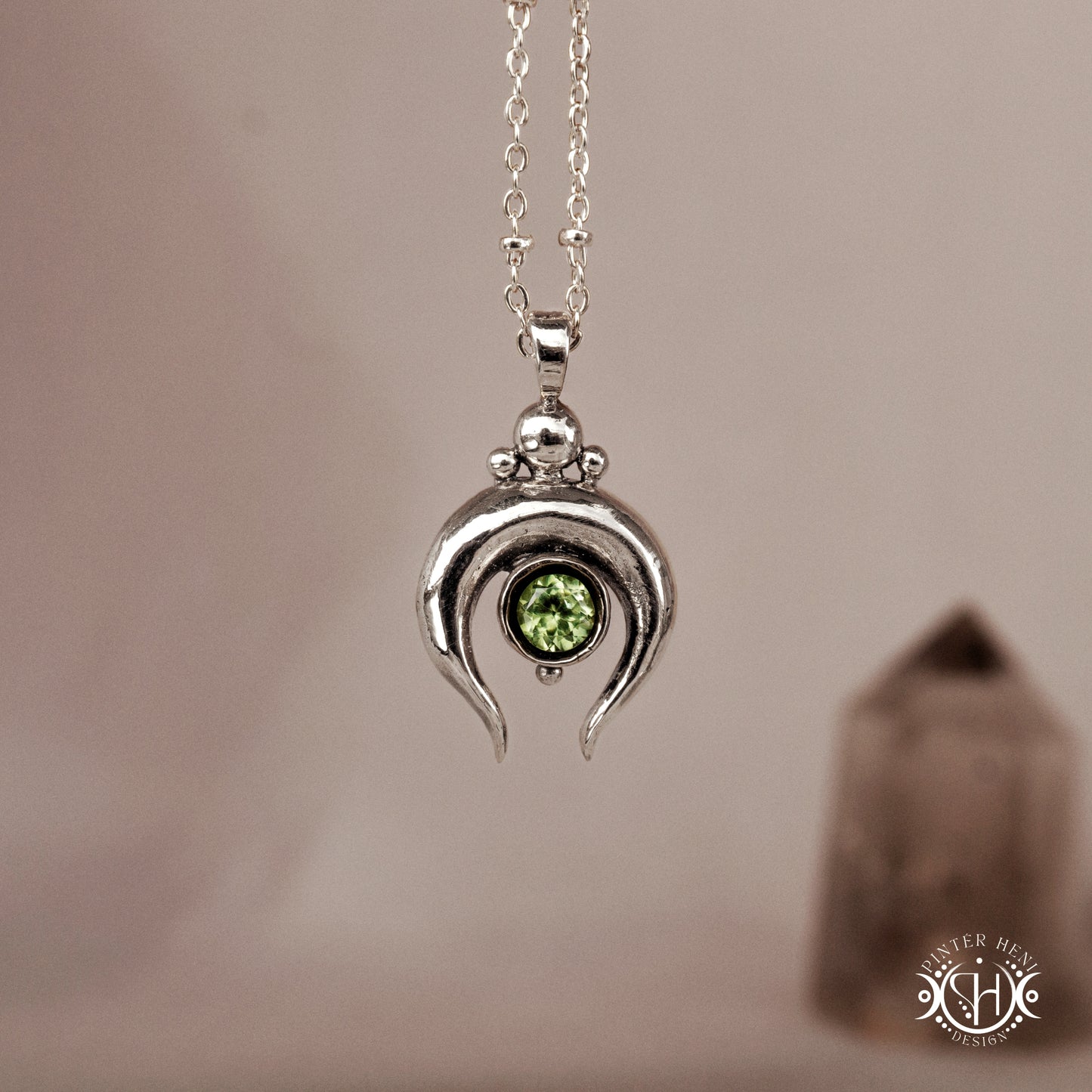 
Hand-carved crescent moon pendant in sterling silver with peridot from the Primal Symbols collection. Symbolic jewelry made to order in brass, silver, and gold.