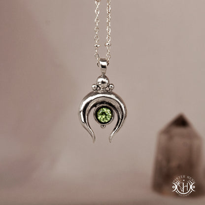 
Hand-carved crescent moon pendant in sterling silver with peridot from the Primal Symbols collection. Symbolic jewelry made to order in brass, silver, and gold.