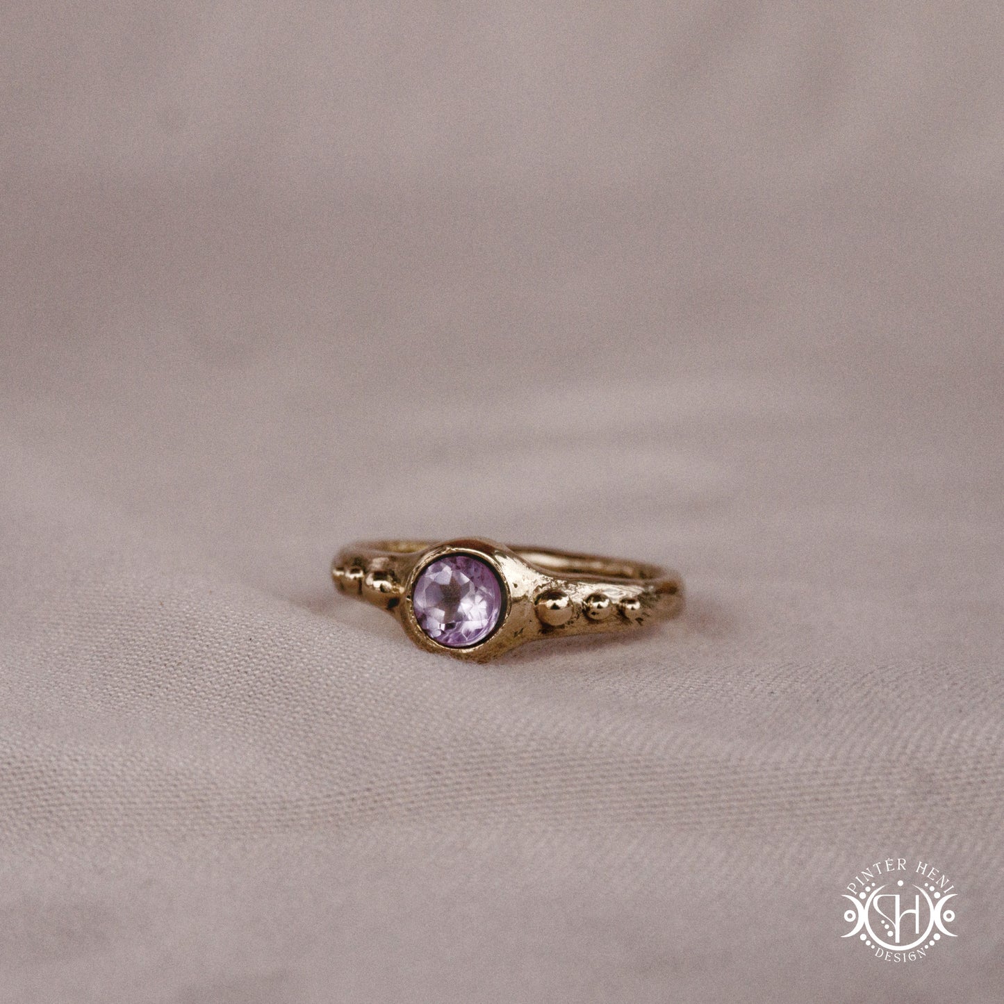 Star Cluster Ring with amethyst and surrounding bead details in handcrafted metal